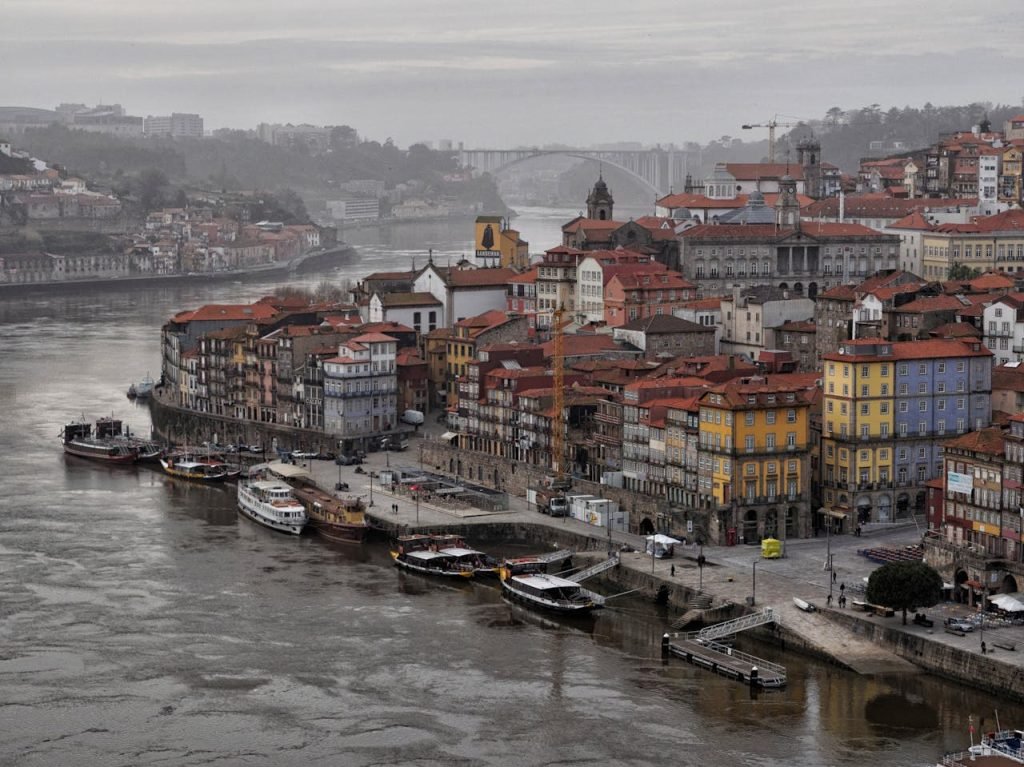 Stunning aerial view of Portos colorful waterfront buildings along Douro River in Portugal.